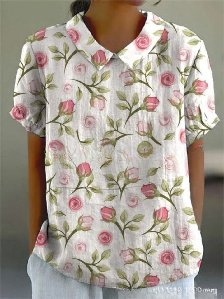 Chic women's short sleeve blouse with a distinctive Peter Pan collar and fashionable all-over print.