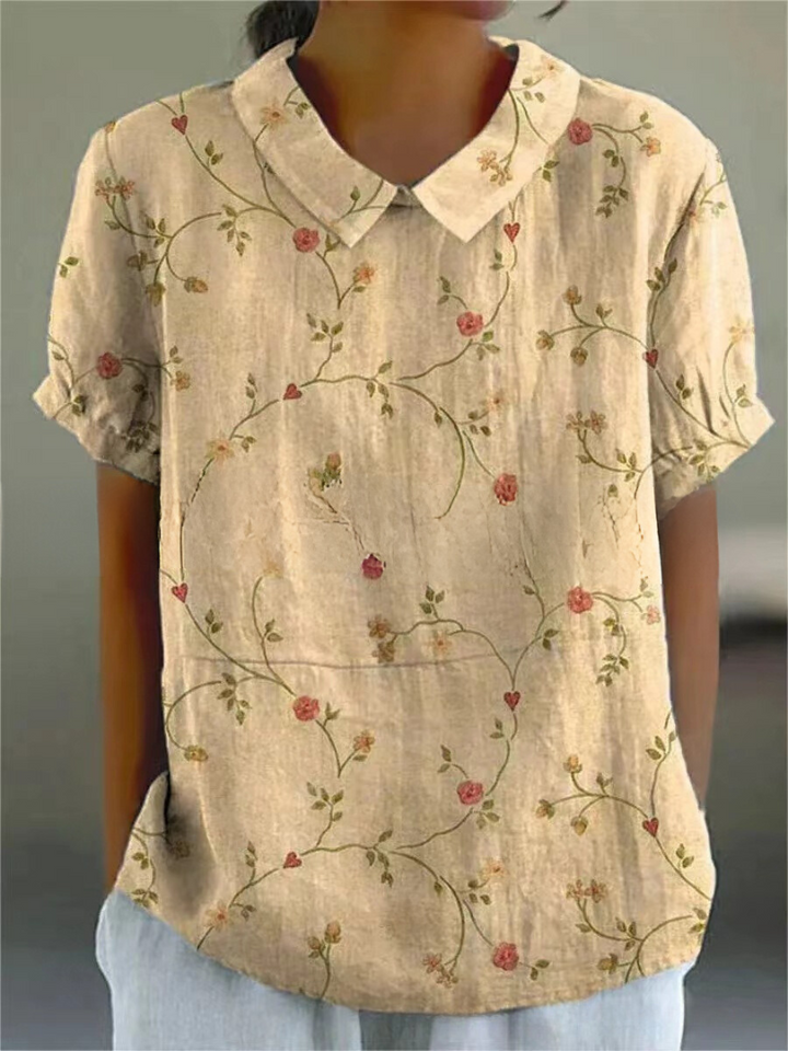 Versatile women's short sleeve blouse with an elegant Peter Pan collar and beautiful patterned print.