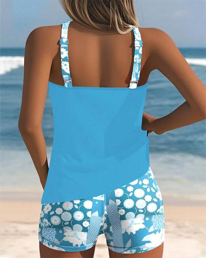 Elegant women's floral tankini with modest swim shorts, a comfortable vacation outfit.