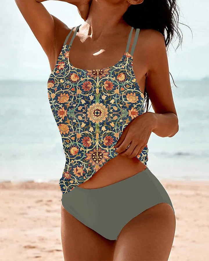 Women's floral tankini swimsuit, high-waisted bottom. Stylish two-piece beachwear with double spaghetti straps.