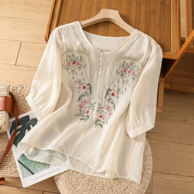 Beautiful floral women's top with a V-neck Henley design and 3/4-sleeves. Relaxed fit for summer comfort.