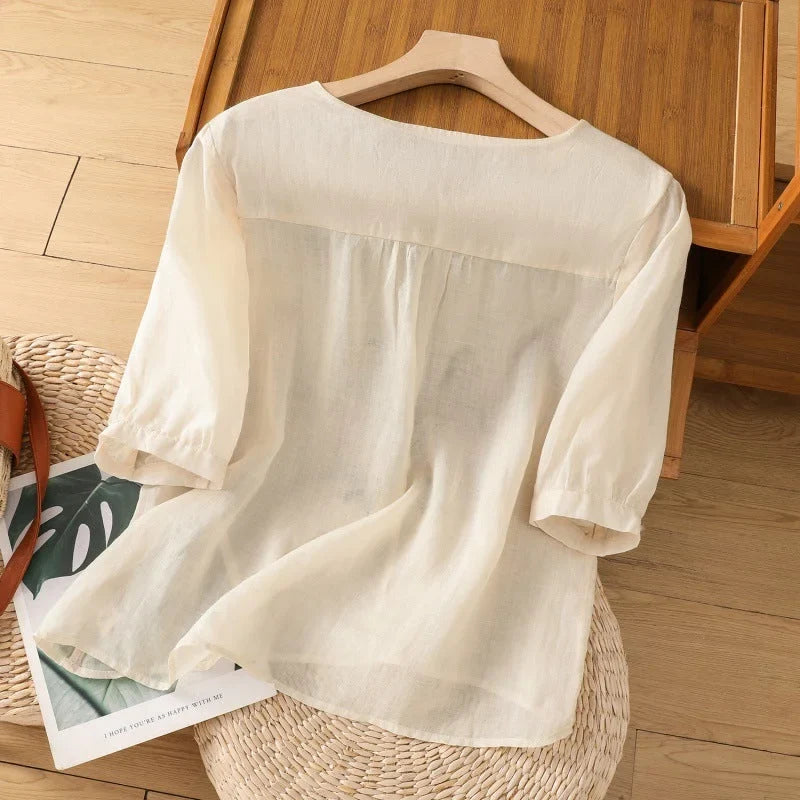 Lightweight women's floral relaxed blouse. V-neck Henley, 3/4-sleeves, ideal for spring & summer casual elegance.