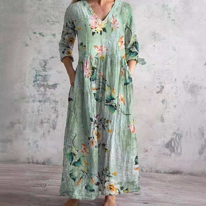 Chic floral V-neck maxi dress for women, featuring three-quarter sleeves, ideal for resort wear.