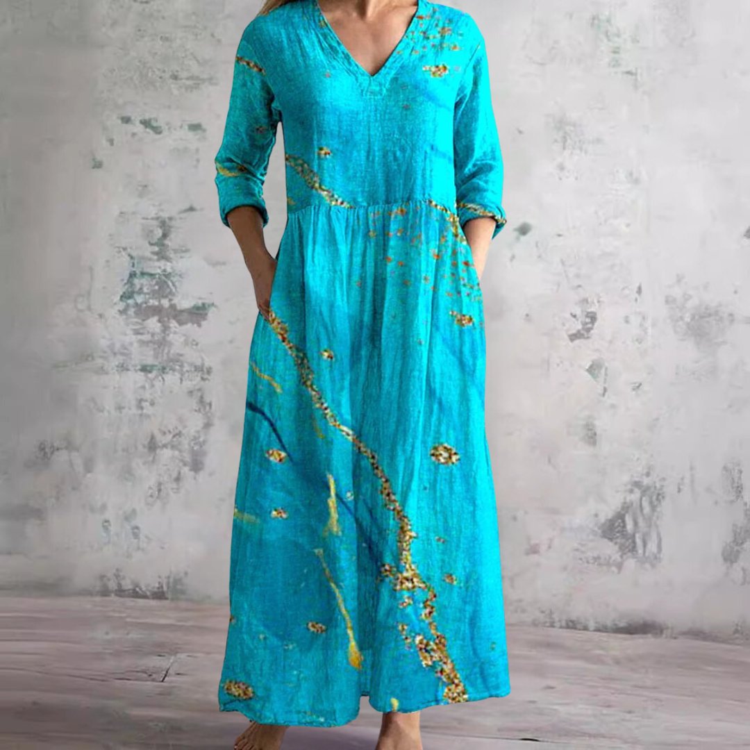 Comfortable women's floral V-neck maxi dress, three-quarter sleeve, embodying effortless summer elegance.