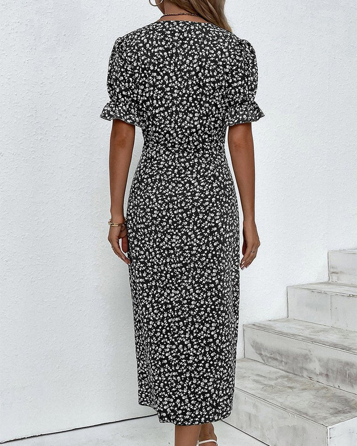 Button detail on a women's floral V-neck midi wrap dress with flattering short sleeves, elegant design.