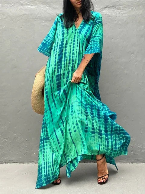 Women's flowing resort maxi dress, elegant vacation style.