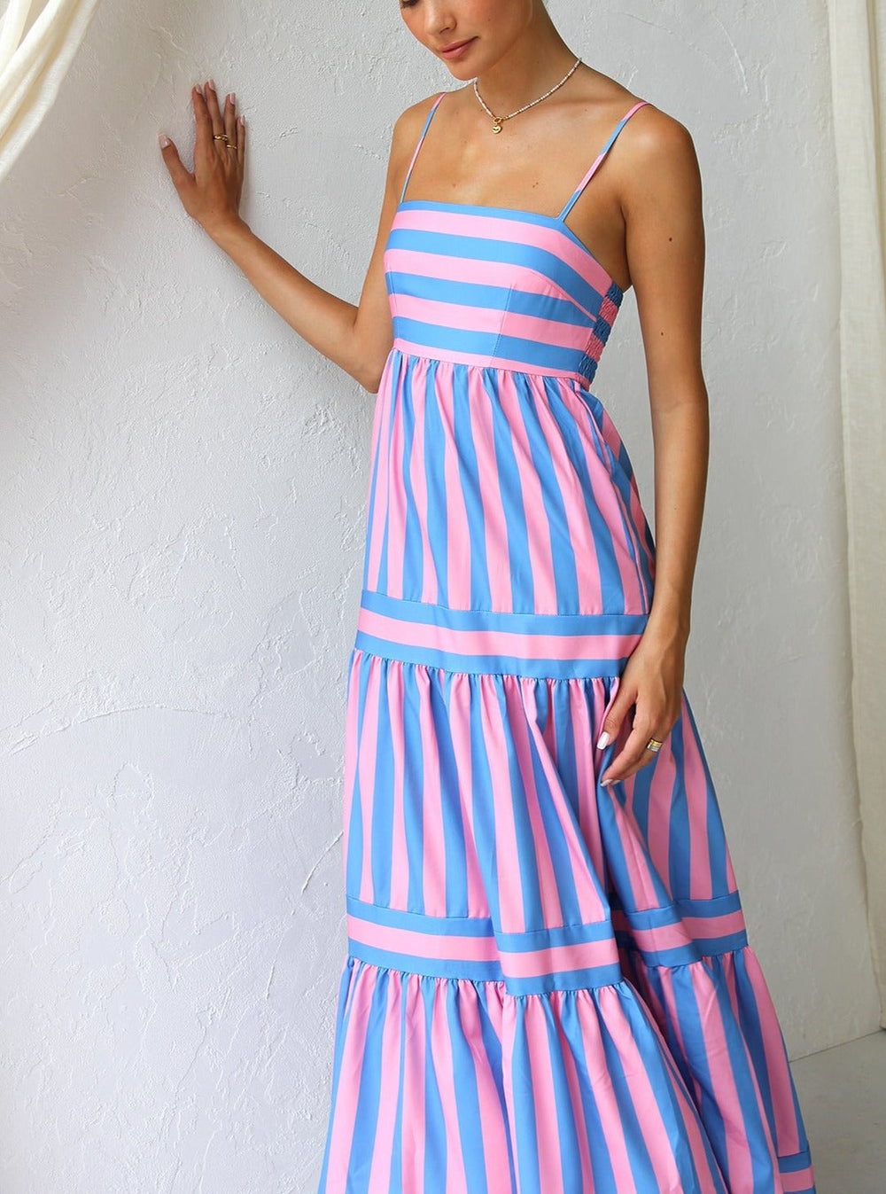 Fashionable women's striped maxi dress, tiered design for a graceful, floor-length silhouette.