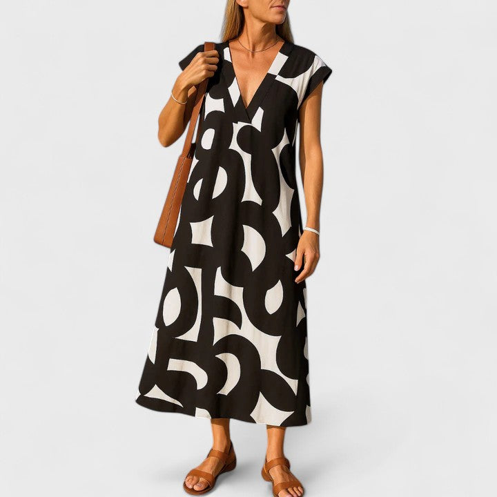 Women's flowing V-neck maxi dress, chic and elegant for summer or holiday wear.
