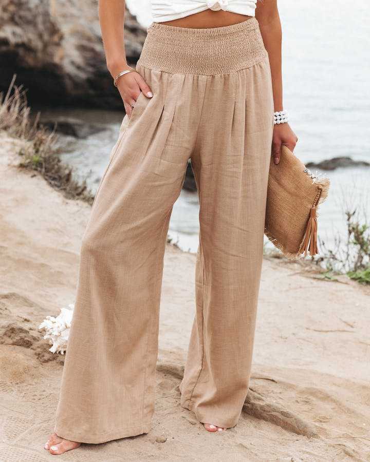 Women's flowing wide-leg beach trousers, ideal for summer resort wear, featuring a comfortable elastic waist.