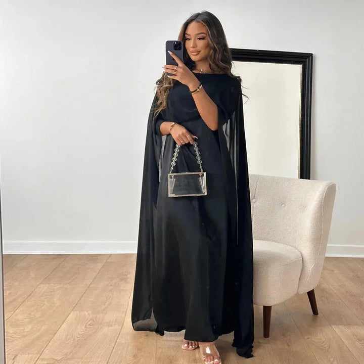 Comfortable women's relaxed fit maxi dress featuring flowy fabric & batwing sleeves, ideal for casual or elegant style.