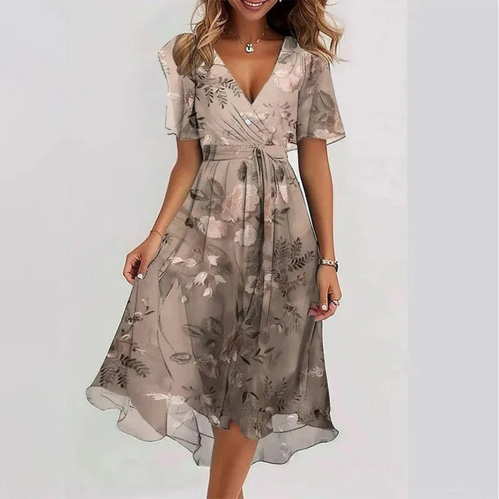 Elegant women's floral knee-length summer dress with a flowy A-line silhouette, V-neck, and short sleeves.