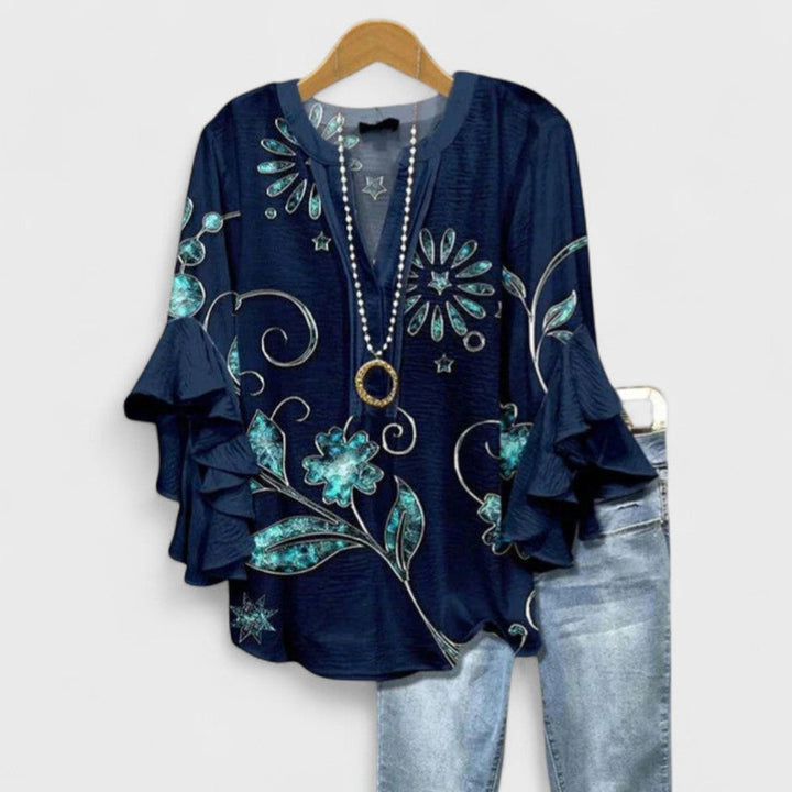 Elegant women's floral blouse, a flowy V-neck top with beautiful ruffle & flare sleeve details.