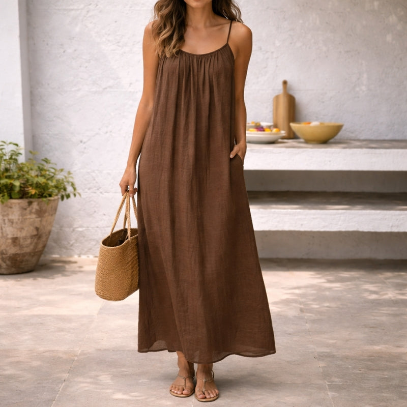 Women's flowy maxi sundress with thin spaghetti straps, perfect for summer beach wear.