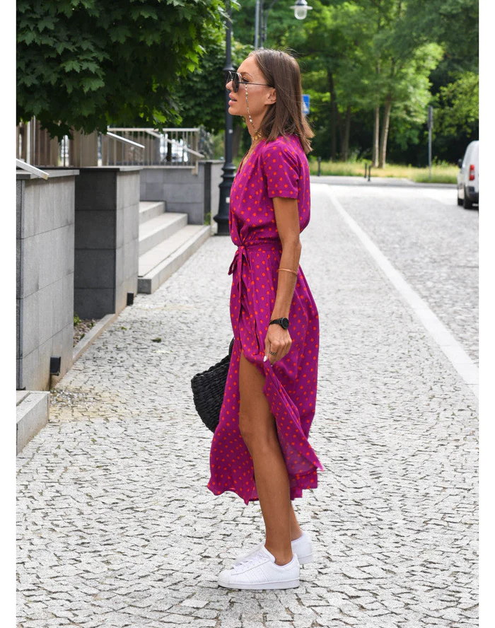 Side profile of a women's printed flowy maxi dress, highlighting its graceful drape and comfortable summer design.