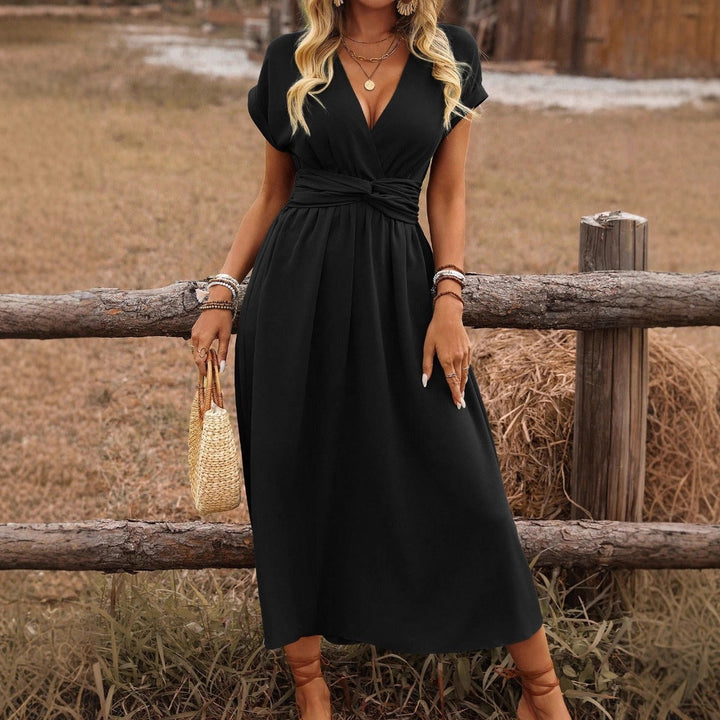 Woman wearing a beautiful flowy V-neck boho maxi dress, perfect as an elegant summer travel outfit.