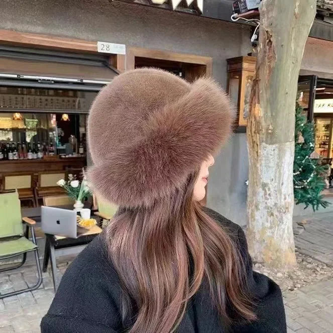 Women's fluffy faux fur winter hat with a stylish wide cuffed brim, perfect for warmth in cold weather.