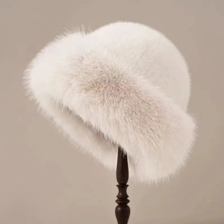 Cozy women's fluffy faux fur winter hat, a warm and fashionable accessory for cold weather, featuring a wide brim.