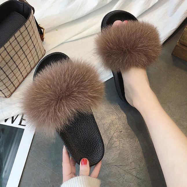 Fashionable fluffy open-toe slide slippers for women, stylish and comfy lounge footwear.