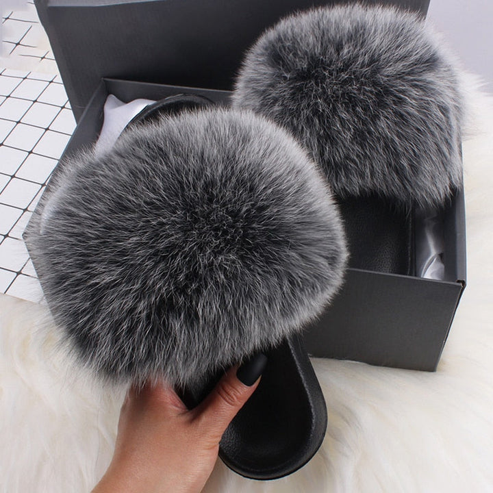 Woman's feet in fluffy open-toe slide slippers, perfect comfort house shoes for relaxation.