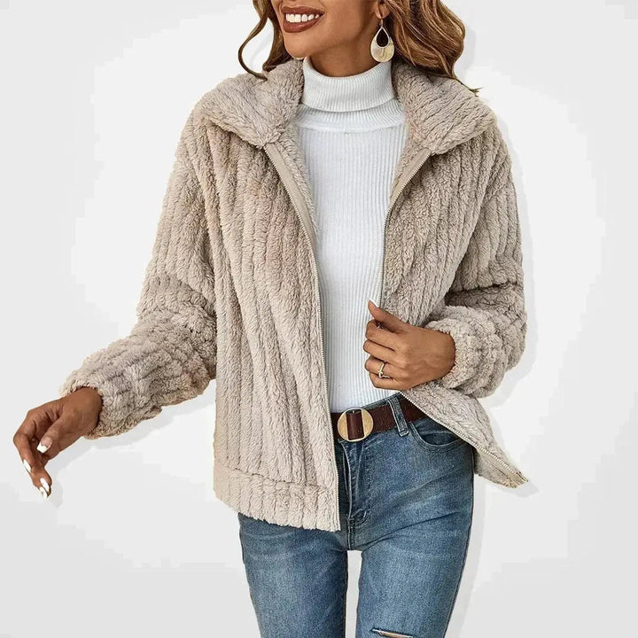 Women's fluffy zip-up quilted jacket, ideal for casual winter warmth & stylish autumn layering. Stay cozy.
