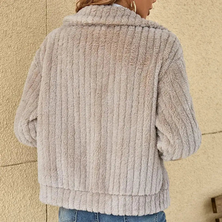Woman in a warm & cozy fluffy zip-up quilted jacket, showcasing its casual style for autumn & winter outings.