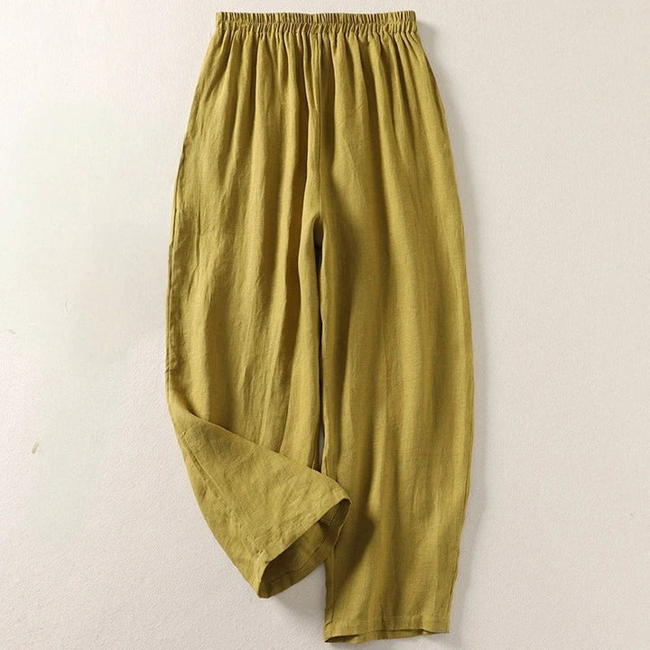 White women's fluid wide-leg cotton blend trousers, featuring a relaxed fit for stylish summer comfort.