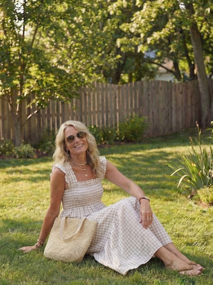 Elegant women's tiered gingham maxi dress, smocked bodice & flutter sleeves. Perfect for versatile summer style.