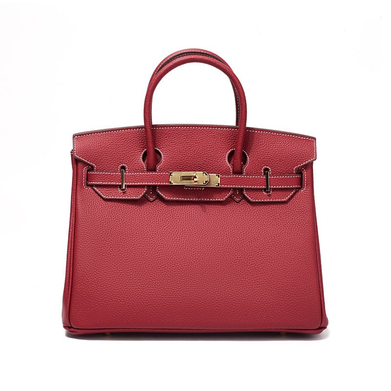 Women's genuine leather handbag, close-up of elegant gold hardware details, luxury purse.
