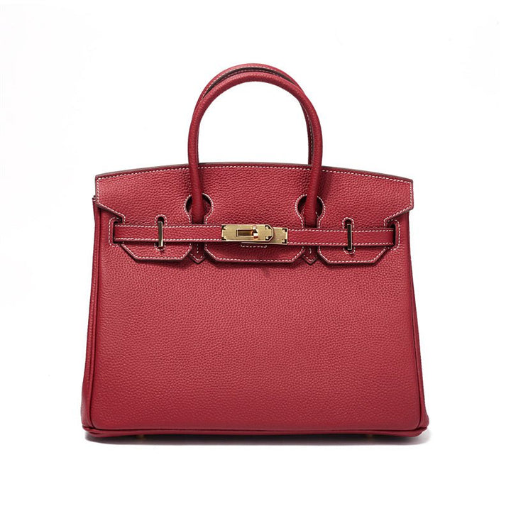 Women's genuine leather handbag, close-up of elegant gold hardware details, luxury purse.