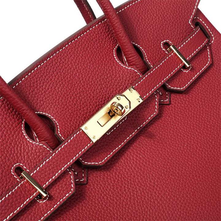 Women's luxury leather handbag, front view, highlighting premium genuine leather texture.