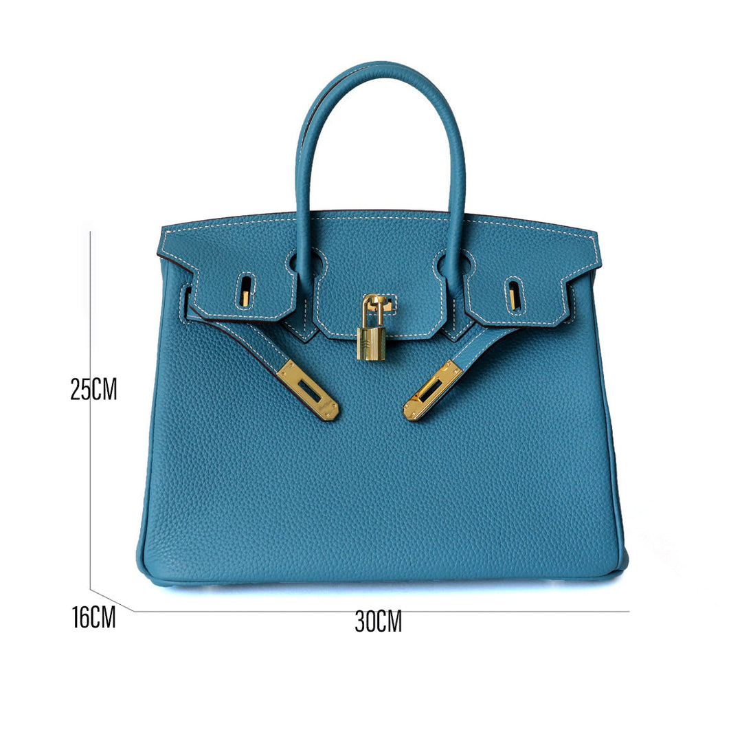 Women's genuine leather work bag, with a laptop inside, demonstrating functionality.