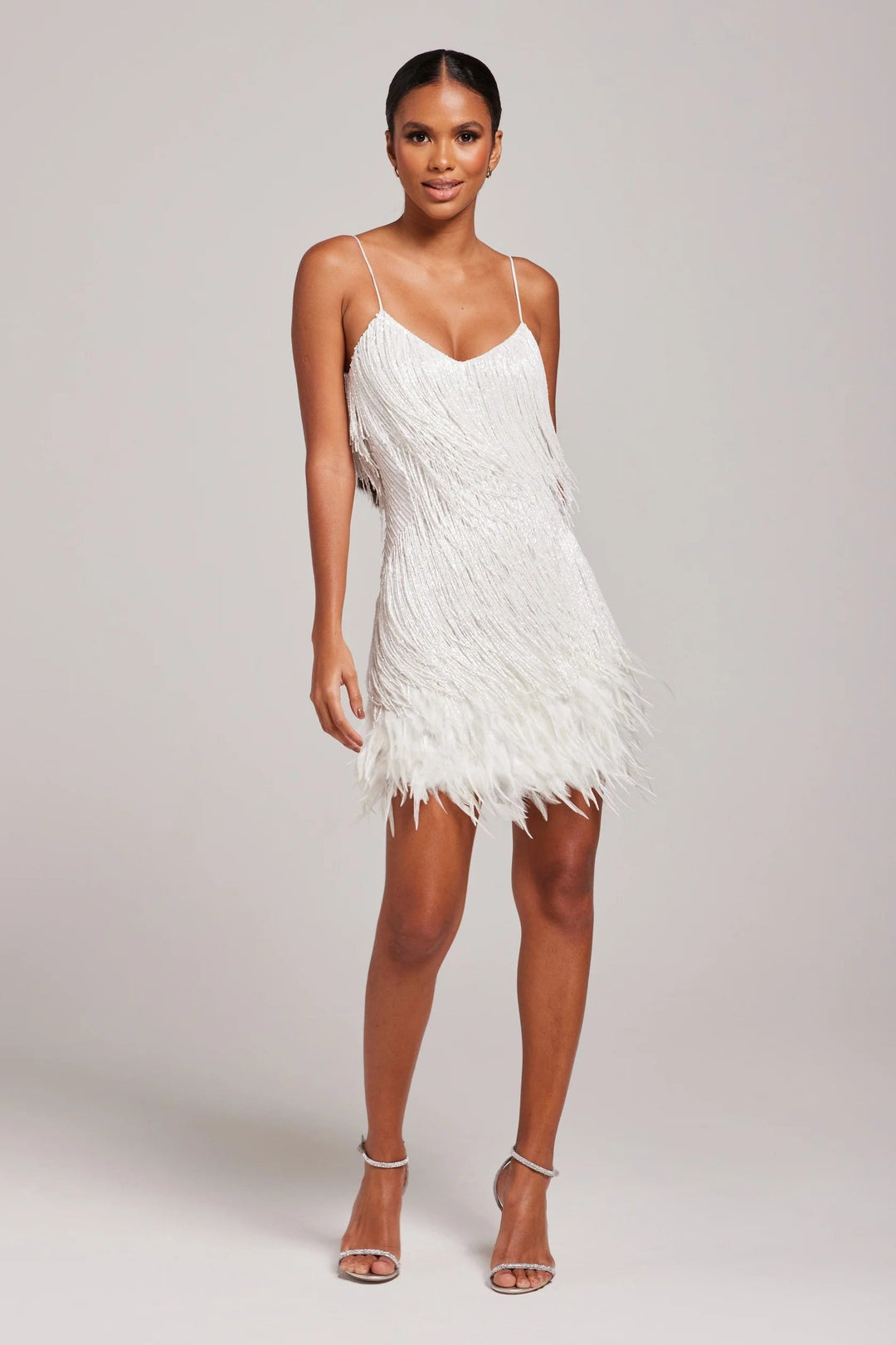 Elegant women's mini cocktail dress featuring intricate fringe and feather embellishments.