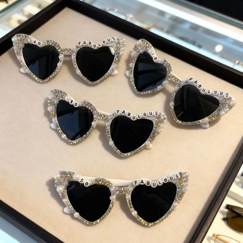 Glamorous women's rhinestone heart sunglasses offering UV protection.