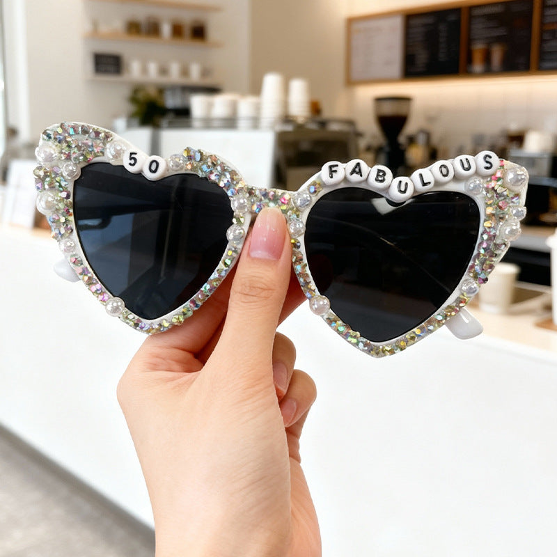 Sparkling women's heart sunglasses with elegant pearl accents, ideal for glamorous looks.