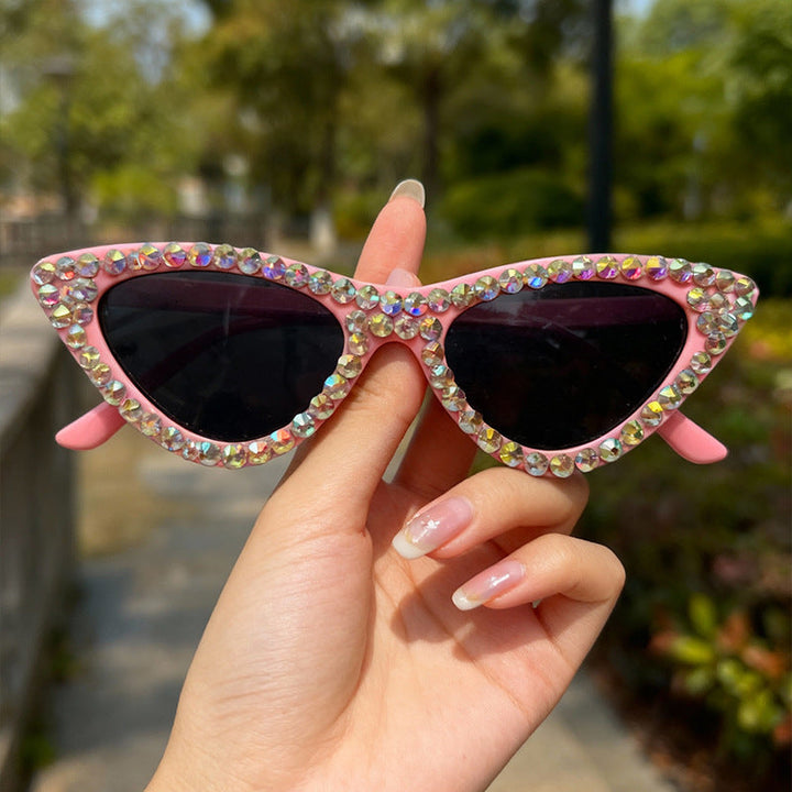 Luxury women's cat-eye sunglasses with dazzling rhinestones, ideal for fashionistas.