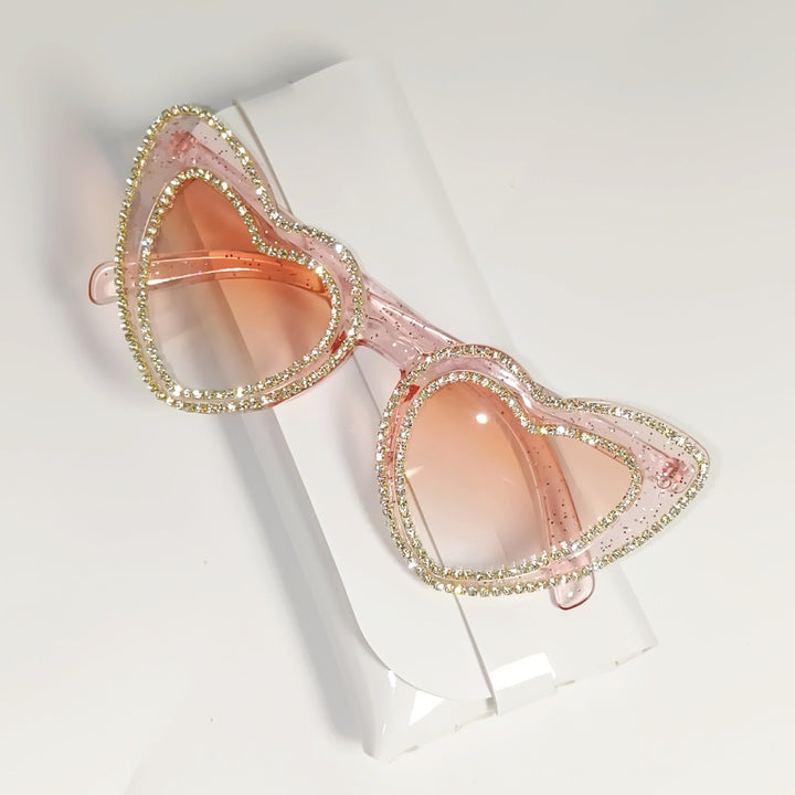Dazzling women's heart-shaped sunglasses, rhinestones add sparkle & provide UV protection.