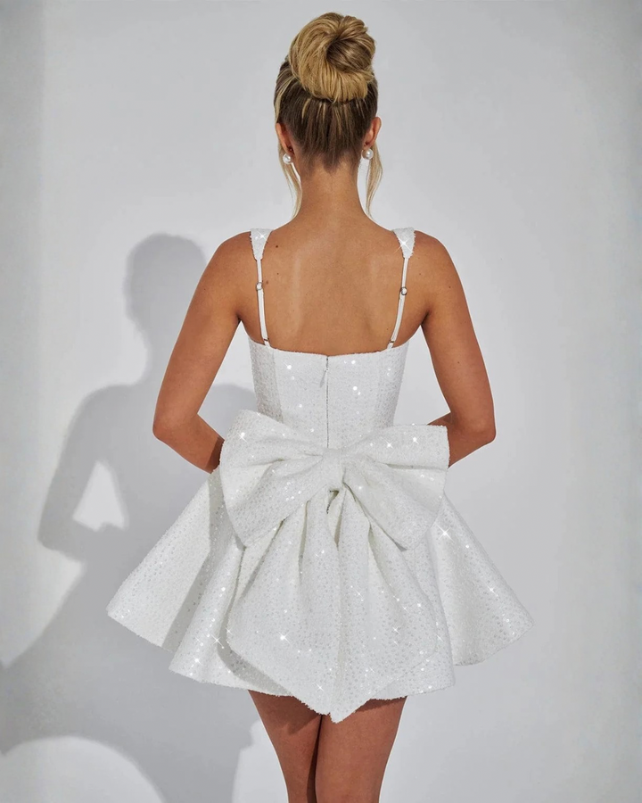 Women's sequin square neck mini dress with a fashionable detachable bow. Glamorous party & evening wear.