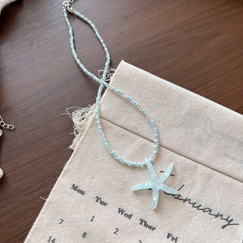 Shimmering glitter fish tail charm necklace, a stylish ocean-inspired accessory for women.