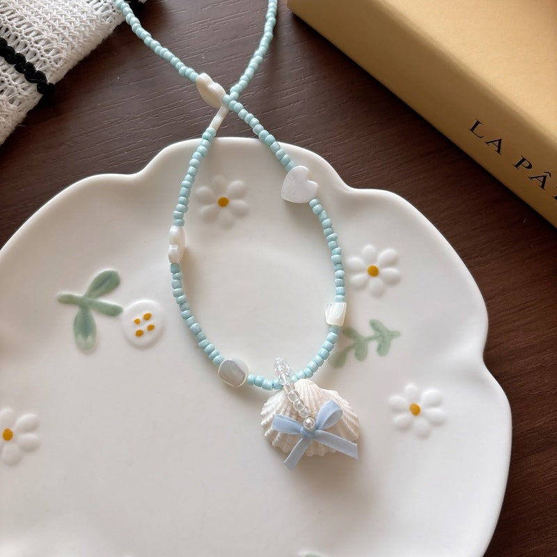 Stylish women's glitter fish tail necklace, a sparkling ocean accessory.
