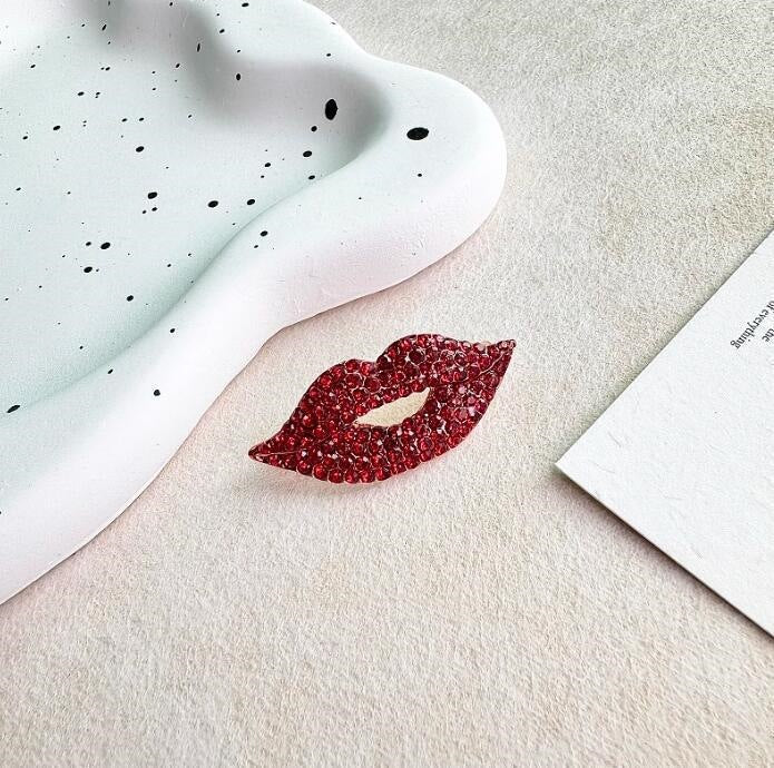 Fashionable women's glittering red lip brooch, a statement pin accessory to enhance any look.