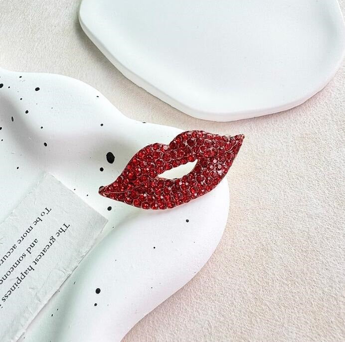 Women's elegant red lip brooch pin with glitter, a sparkling fashion accessory perfect for gifting.