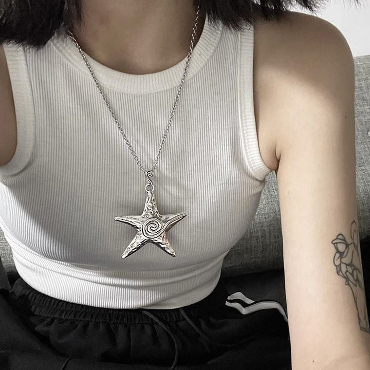 Close-up of a delicate metal star pendant on a women's adjustable chain necklace, celestial fashion jewelry.