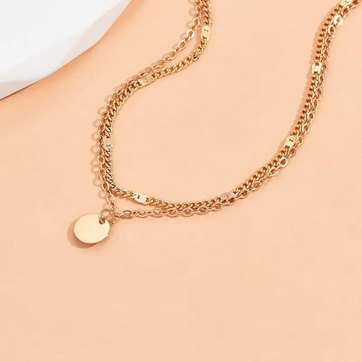 Adjustable gold layered anklet featuring multiple delicate charms, ideal women's summer jewelry.