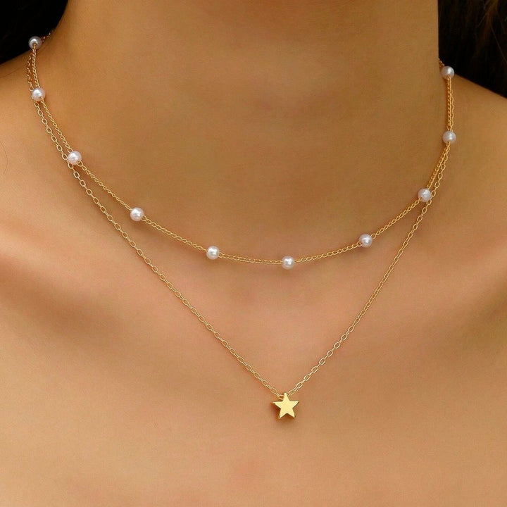 Elegant gold plated layered necklace for women, featuring a delicate design with lustrous pearl & charming star pendants.