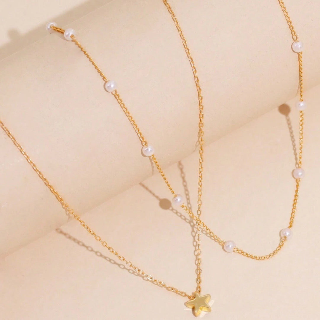 Delicate women's gold plated necklace, a layered design with pearl and star charms, perfect fashion gift for her.