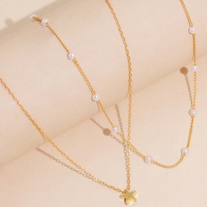 Delicate women's gold plated necklace, a layered design with pearl and star charms, perfect fashion gift for her.