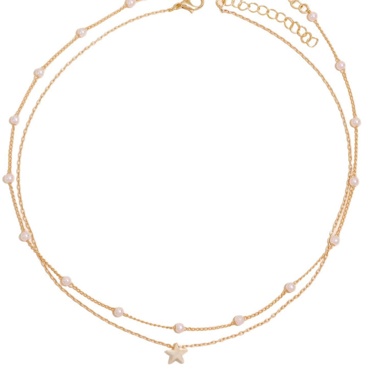 Fashionable women's gold plated layered necklace, featuring delicate pearl and star charms for an elegant look.
