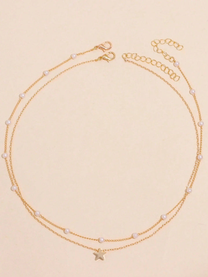 Chic women's gold-plated layered necklace, showcasing a blend of delicate pearl charms & twinkling star pendants.