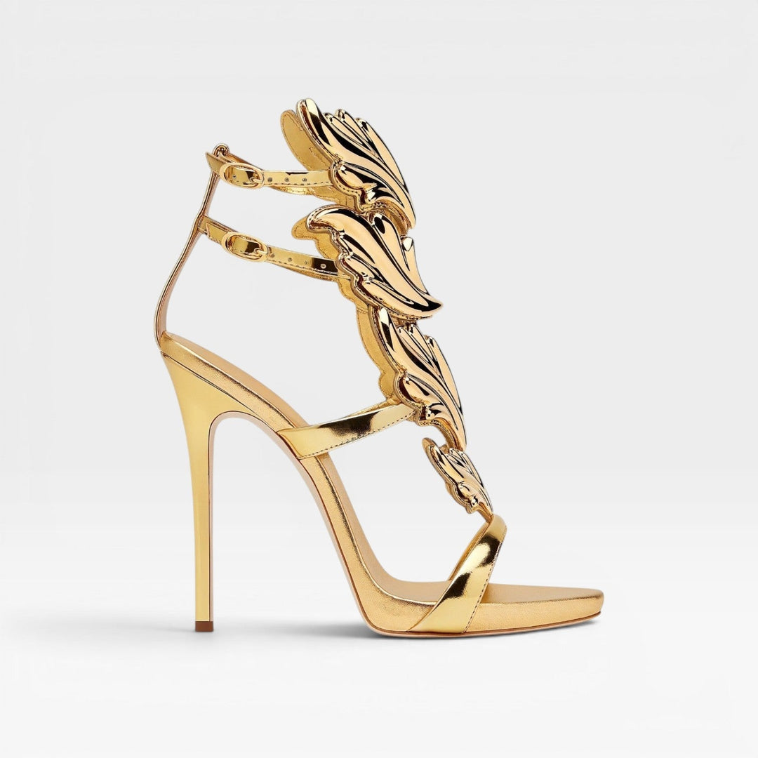 Luxury gold metallic strappy stiletto sandals with sculptural wings, perfect for formal evenings & weddings.