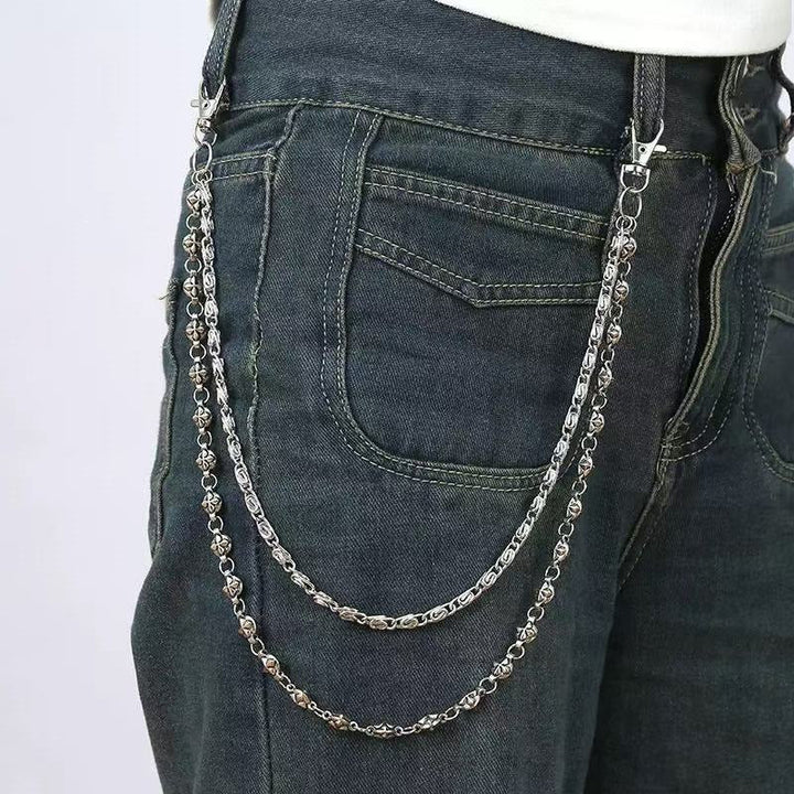 Women's gold-tone chain belt with elegant decorative pendants. Chic fashion accessory for waist.